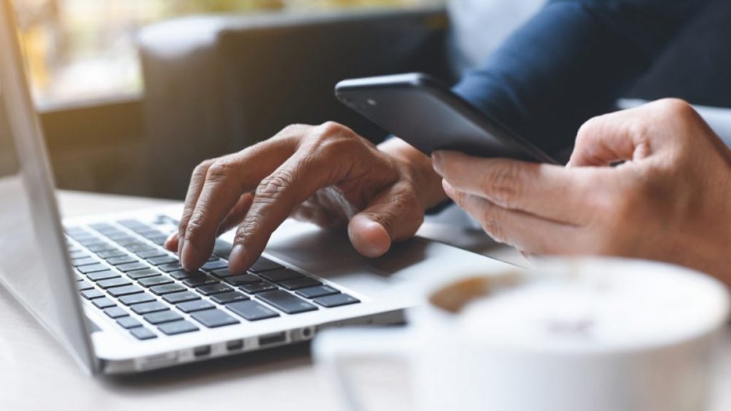 man on phone and laptop