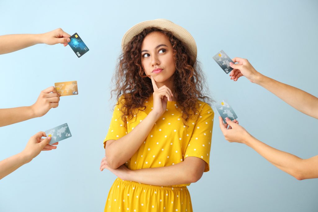 thoughtful woman with many credit card offers