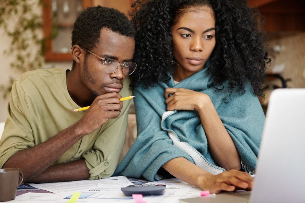 couple with debts calculating bills