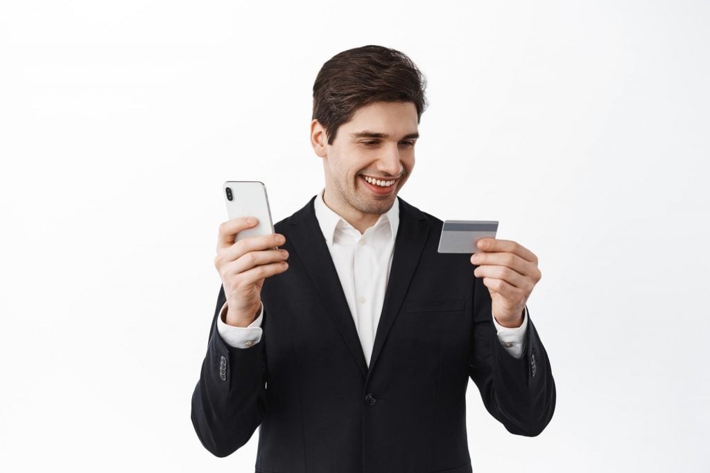 business man using credit card on smartphone