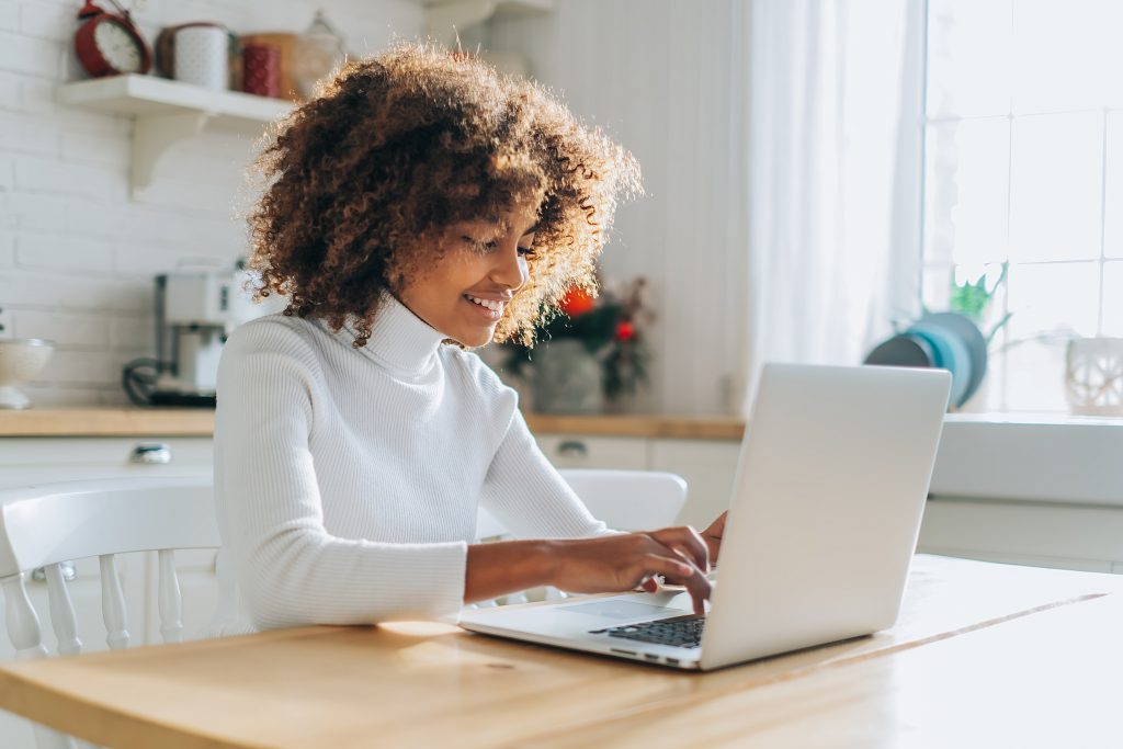 girl looks in laptop and enjoys online shopping