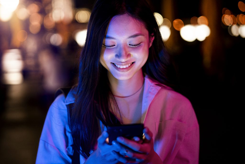 portrait-beautiful-woman-using-smartphone-night-city-lights