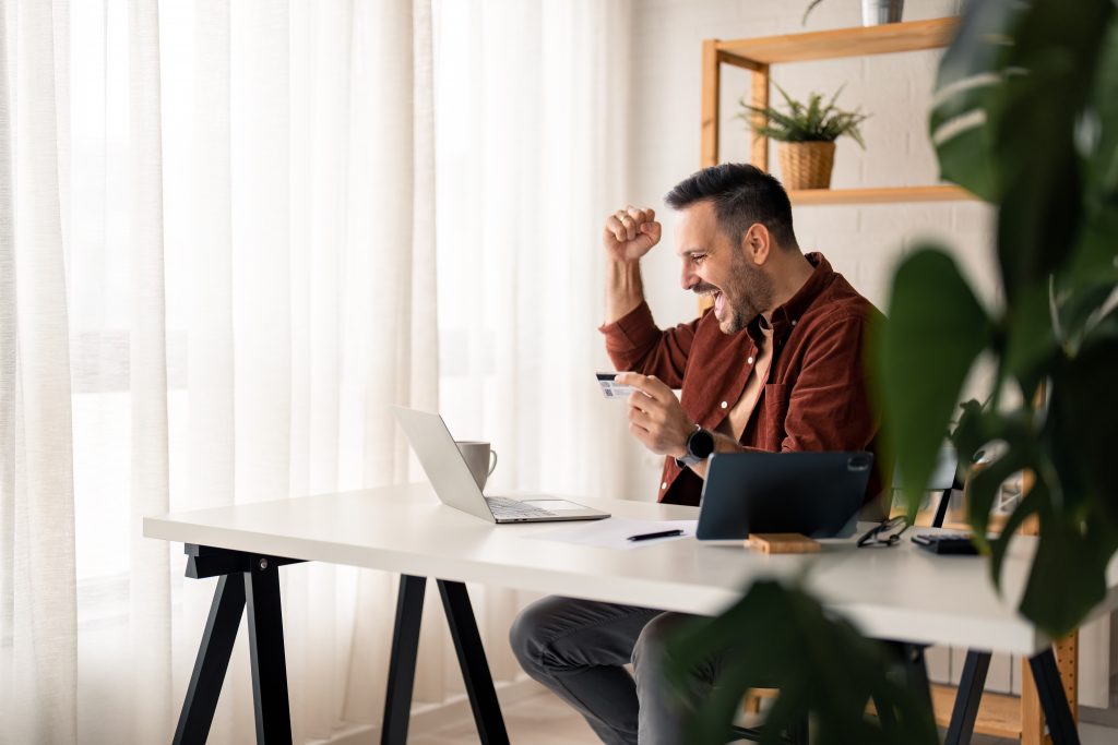 Enthusiastic handsome millennial man feeling excited looking at