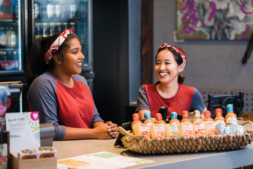 picture of two girls smiling working at Nando's