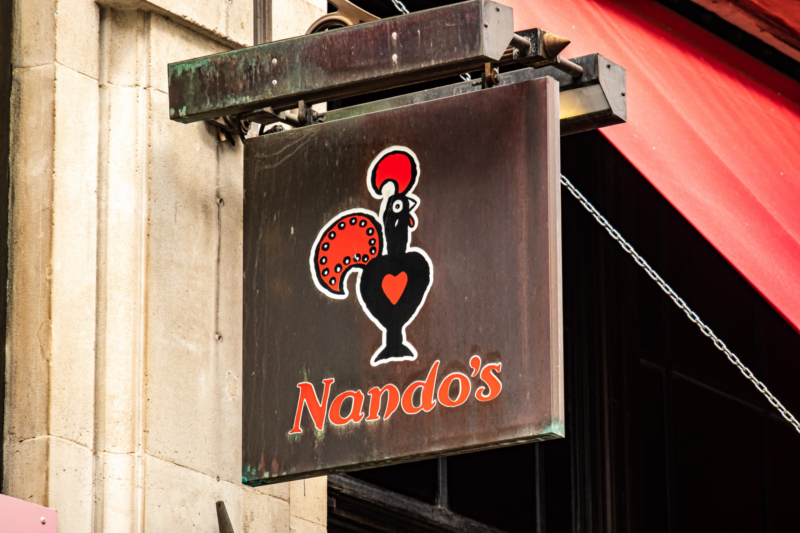 Nandos logo on exterior signage, a popular grilled chick