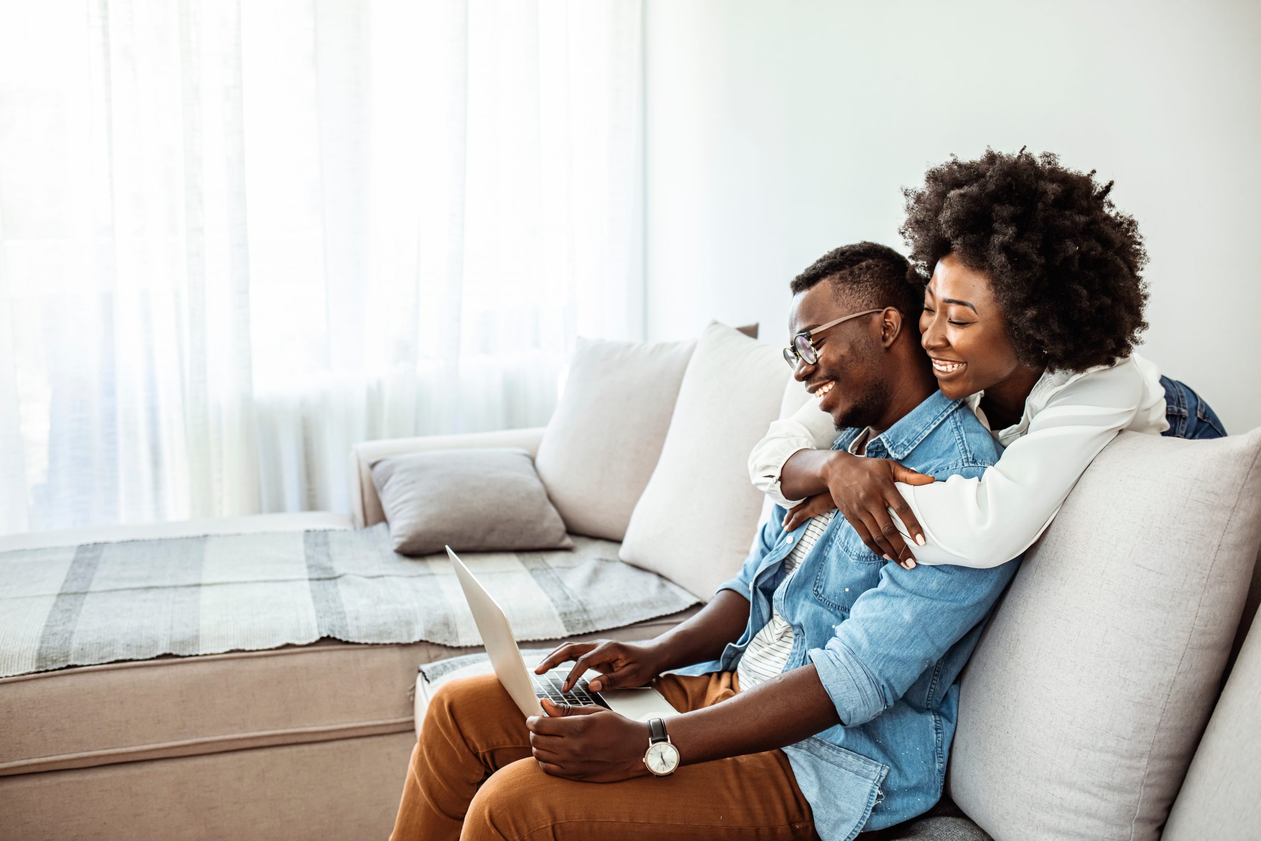 Happy young african couple with laptop computer. Happy black cou