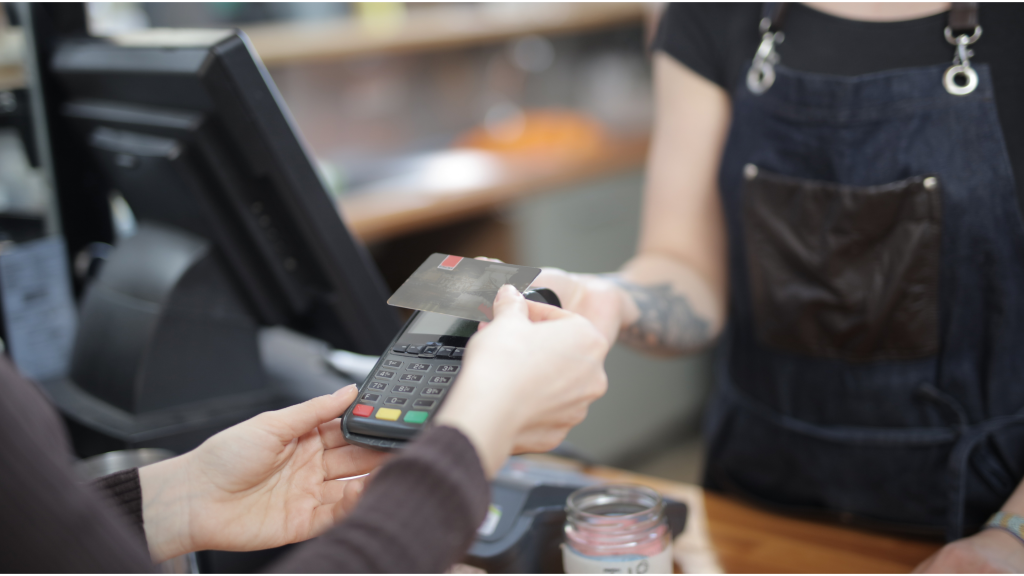 Person using a credit card with a credit card machine