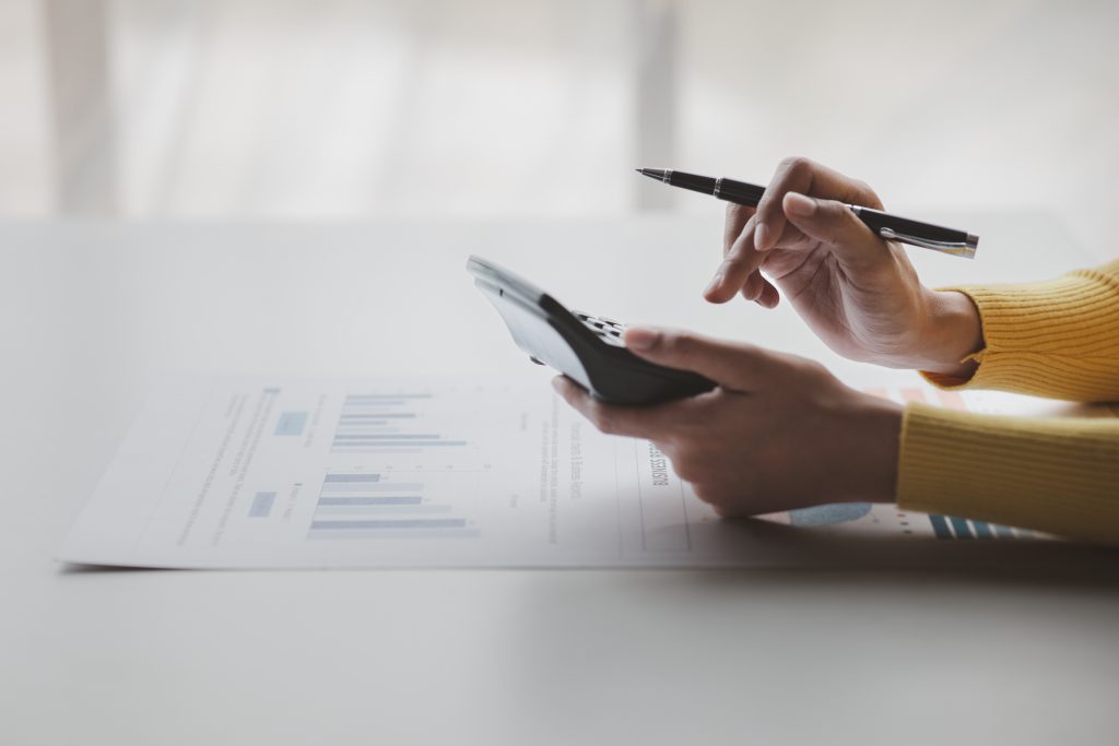 Businessman using a calculator to calculate numbers on a company